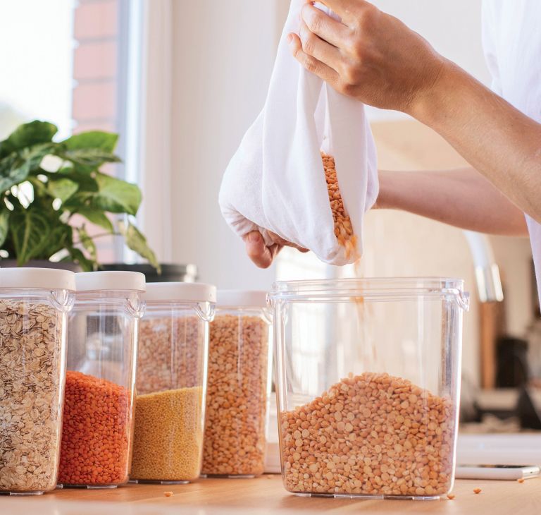 A storage container of grains is refilled. 
