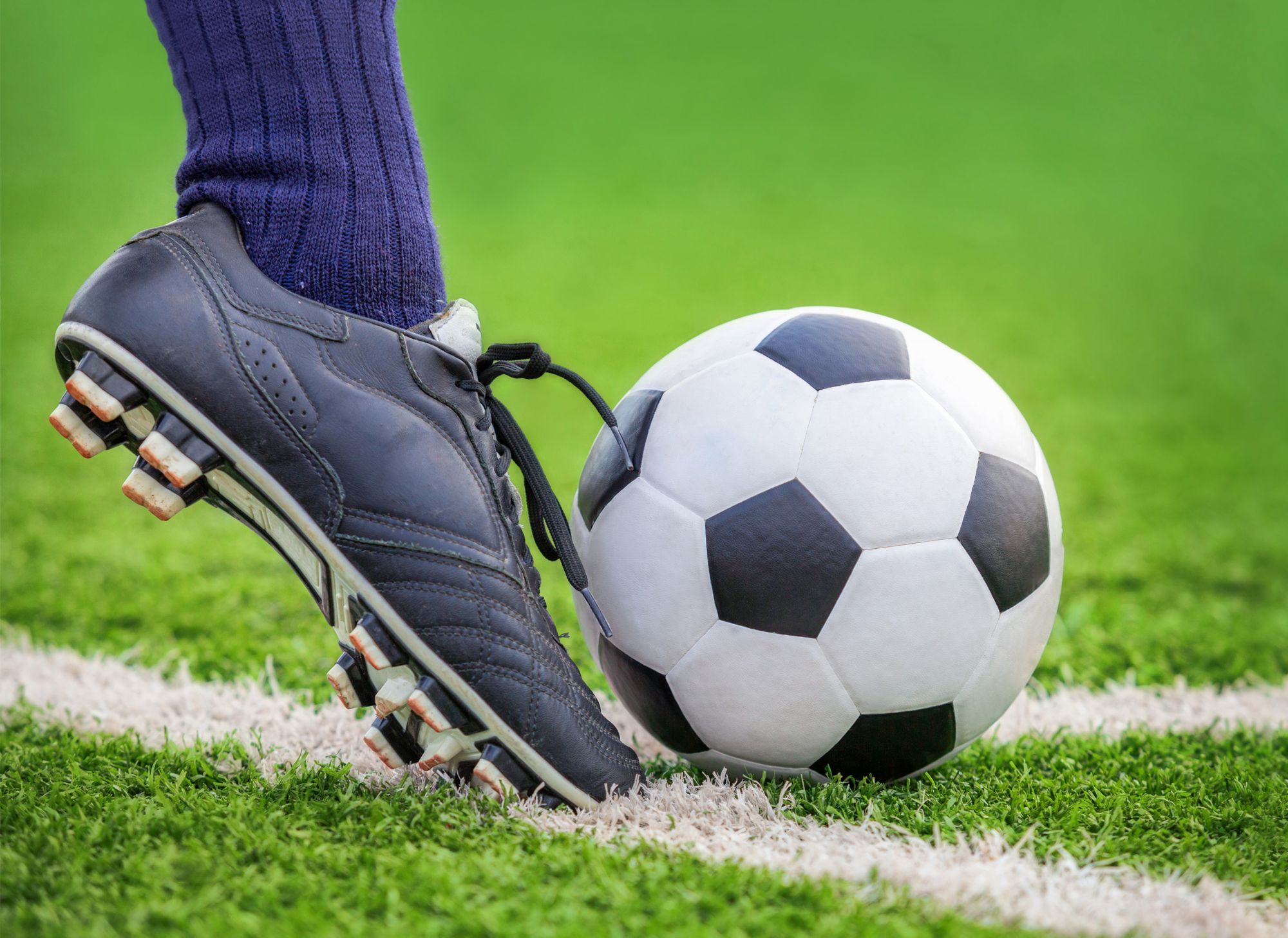 Close up of foot kicking a soccer ball. 