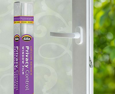 Retail packaging displayed next to a window treated with the Frosted Botanical decorative film.