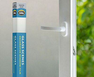 Retail packaging displayed next to a window treated with the Frosted Glass decorative film.
