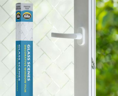 Retail packaging displayed next to a window treated with the Frosted Tiles decorative film.