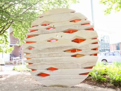 round statue with orange pieces of glass