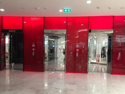 red colored glass facade of the shopping mall