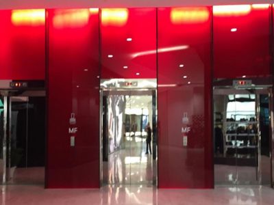 red colored glass facade of the shopping mall
