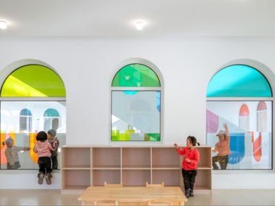 kids playing in front of colorful windows