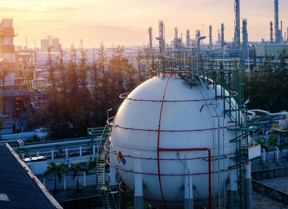 A large white spherical storage tank on a rooftop.   