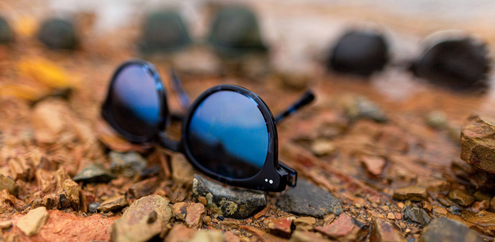 Sunglasses scattered across the rocky ground. 