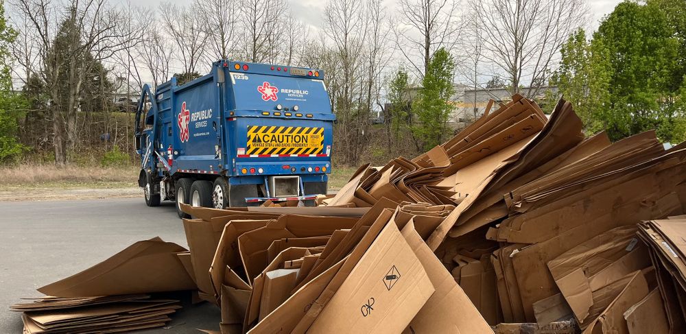 A pile of cardboard boxes waits to be picked up on a truck 