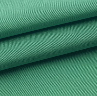 Close-up of folded emerald-green fabric