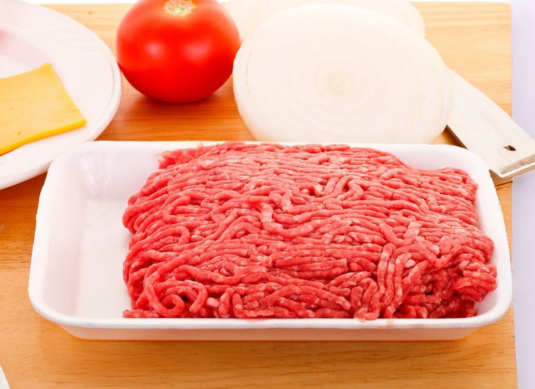 Ground meat sits in a white protein tray. 