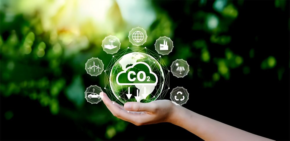 Hand holding a holographic Earth with icons to help reduce carbon dioxide emissions. 