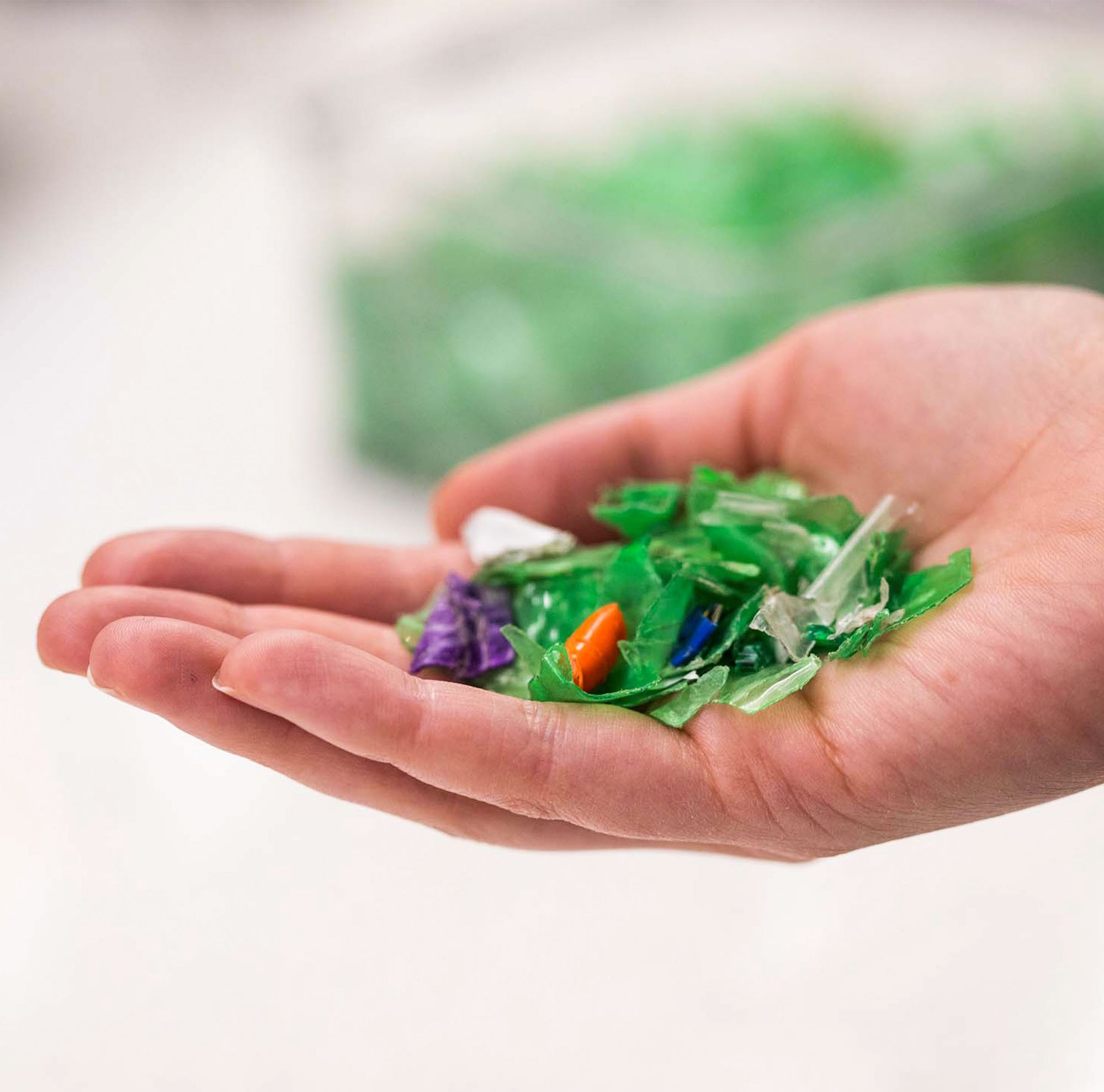 Large bales of stacked, mixed plastic waste. 