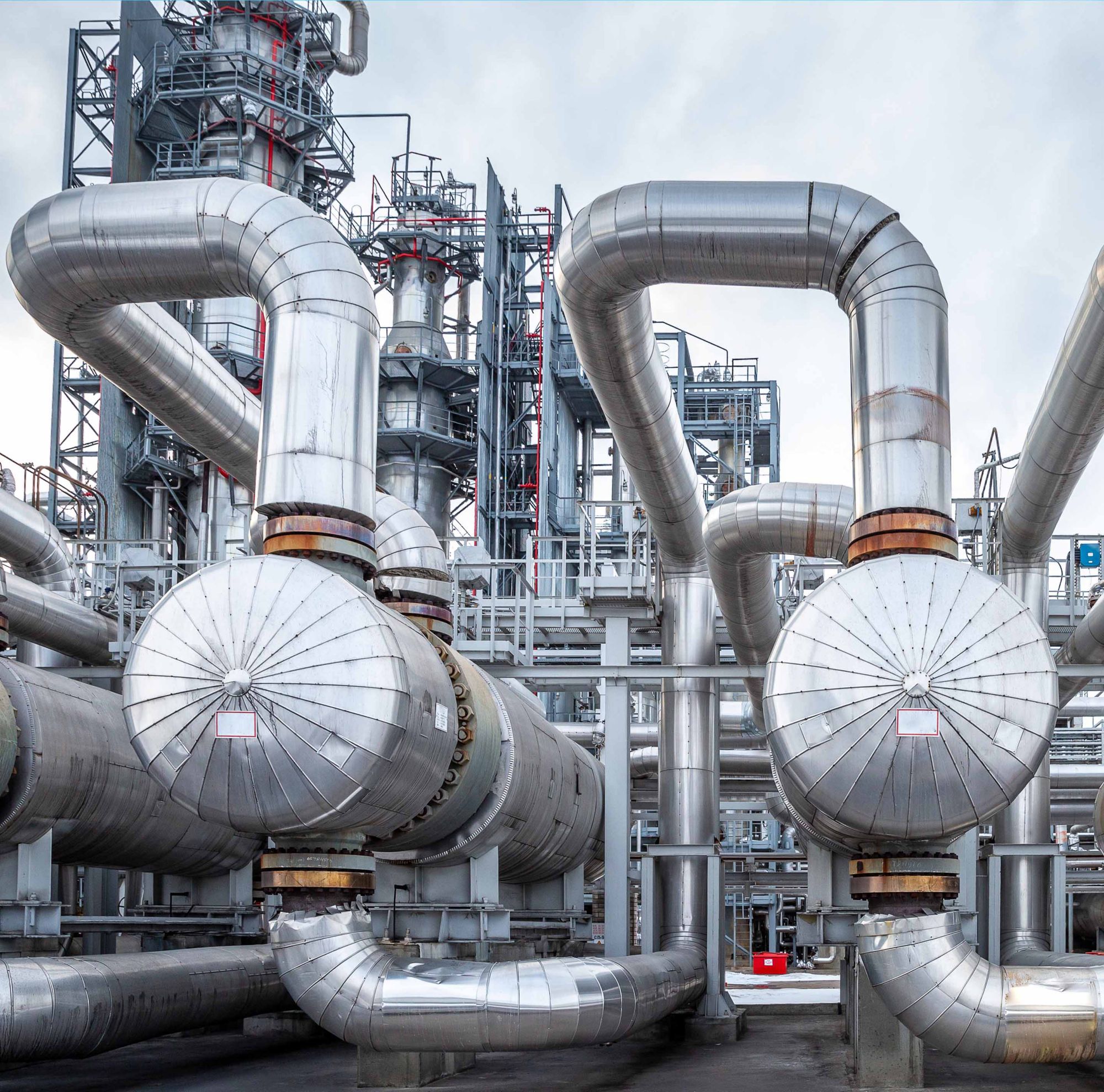 An exterior photo of winding pipe in an oil refinery heat exchanger.  
