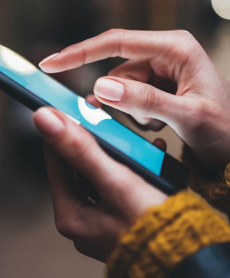 A close-up shot of someone using a cellphone 