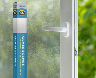 Retail packaging displayed next to a window treated with the Ice Chips decorative film.