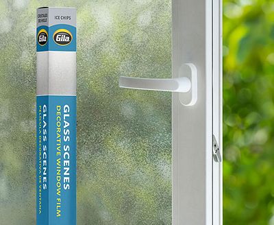 Retail packaging displayed next to a window treated with the Ice Chips decorative film.