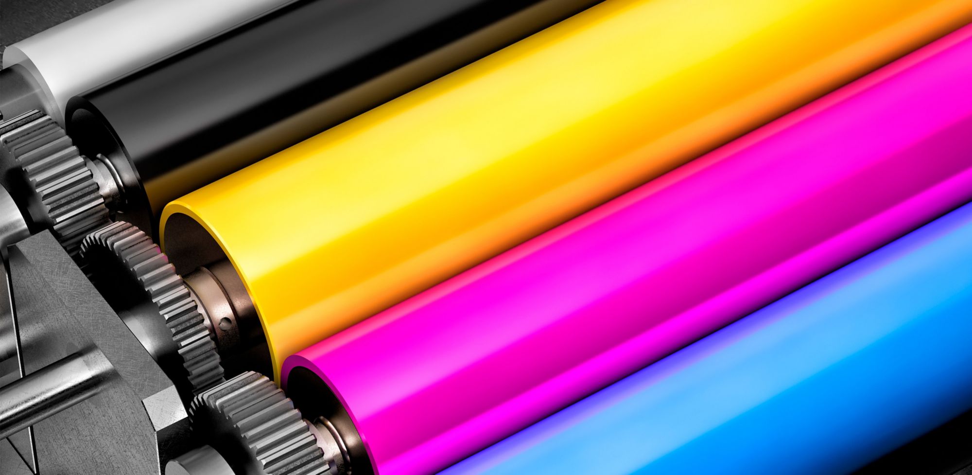 Glossy rollers of a printing machine featuring black, yellow, pink and blue colors. 