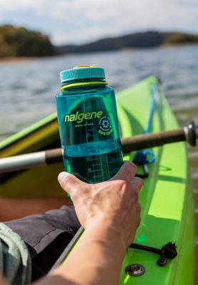 Kayaker on lake uses water bottle made with Eastman Tritan