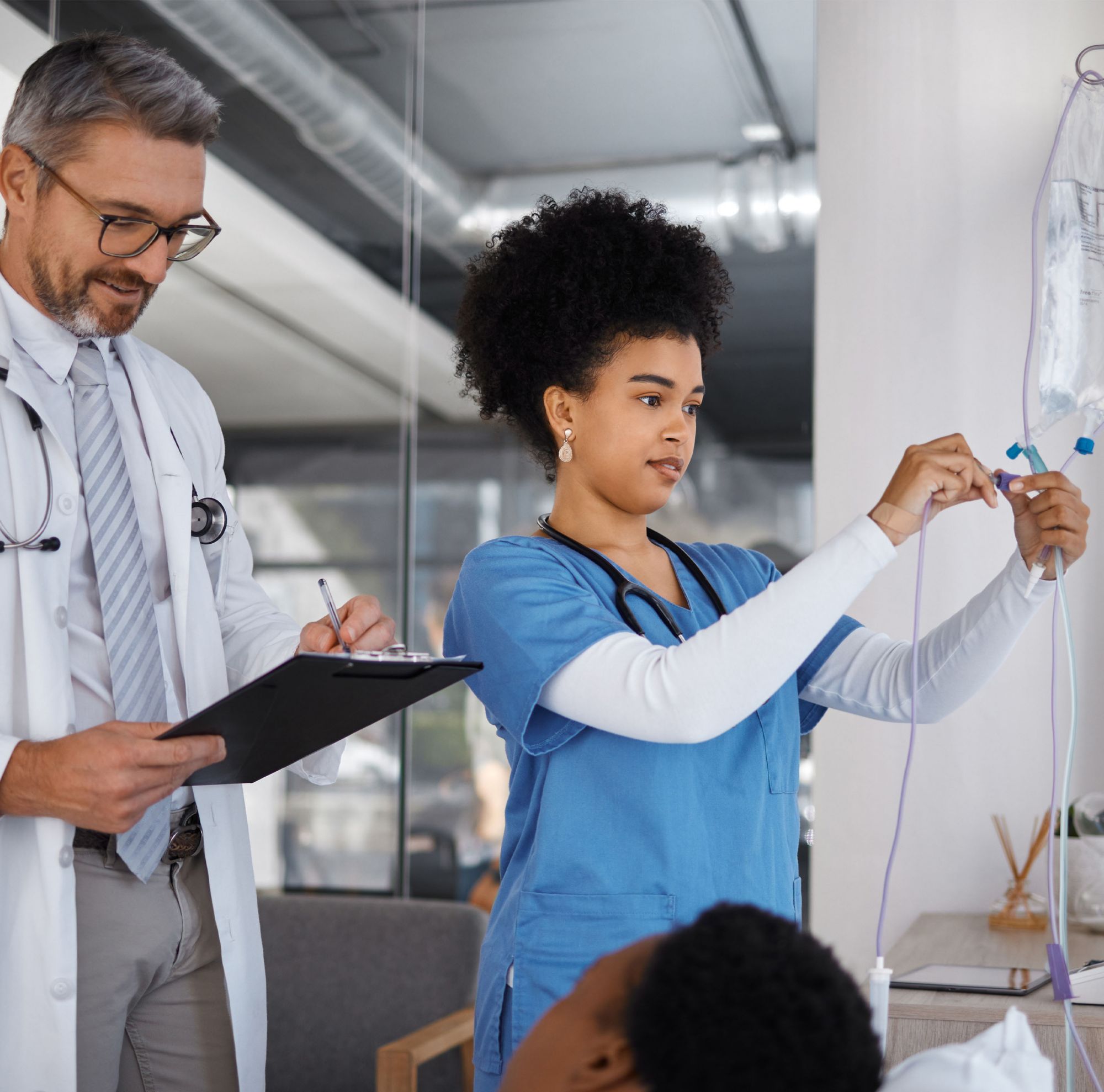 Two medical professionals talking to a patient. 