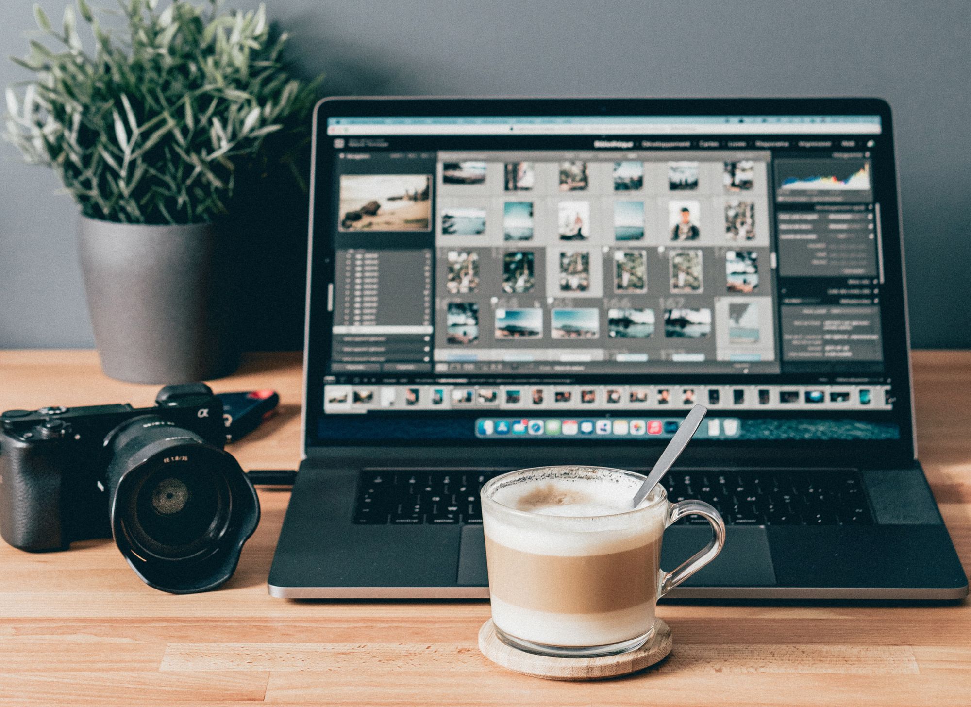 Black laptop computer beside white ceramic mug on brown wooden table 