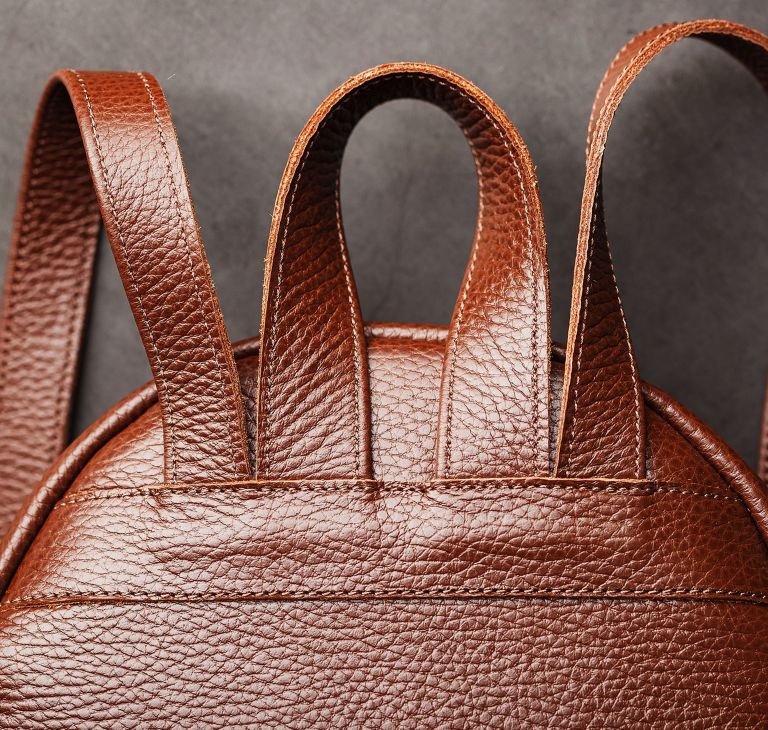 Close-up of leather straps on a backpack. 