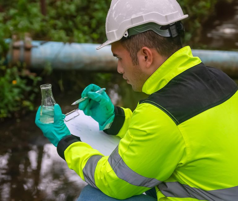 A man examines a water sample. 
