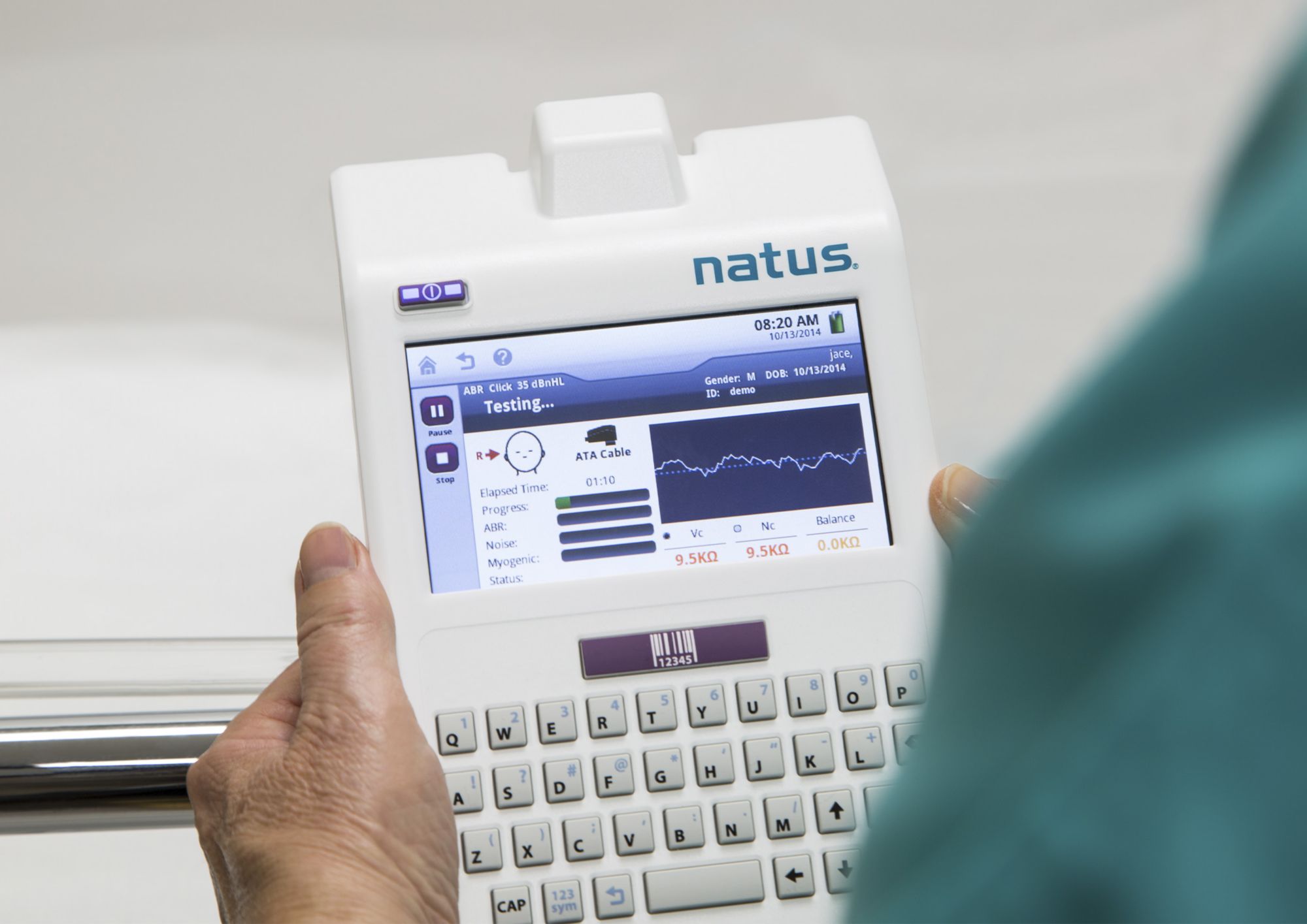 Two people holding a medical device on a bed 