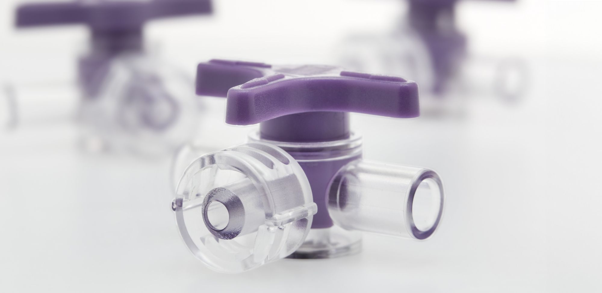A purple three-way stopcock valve.   