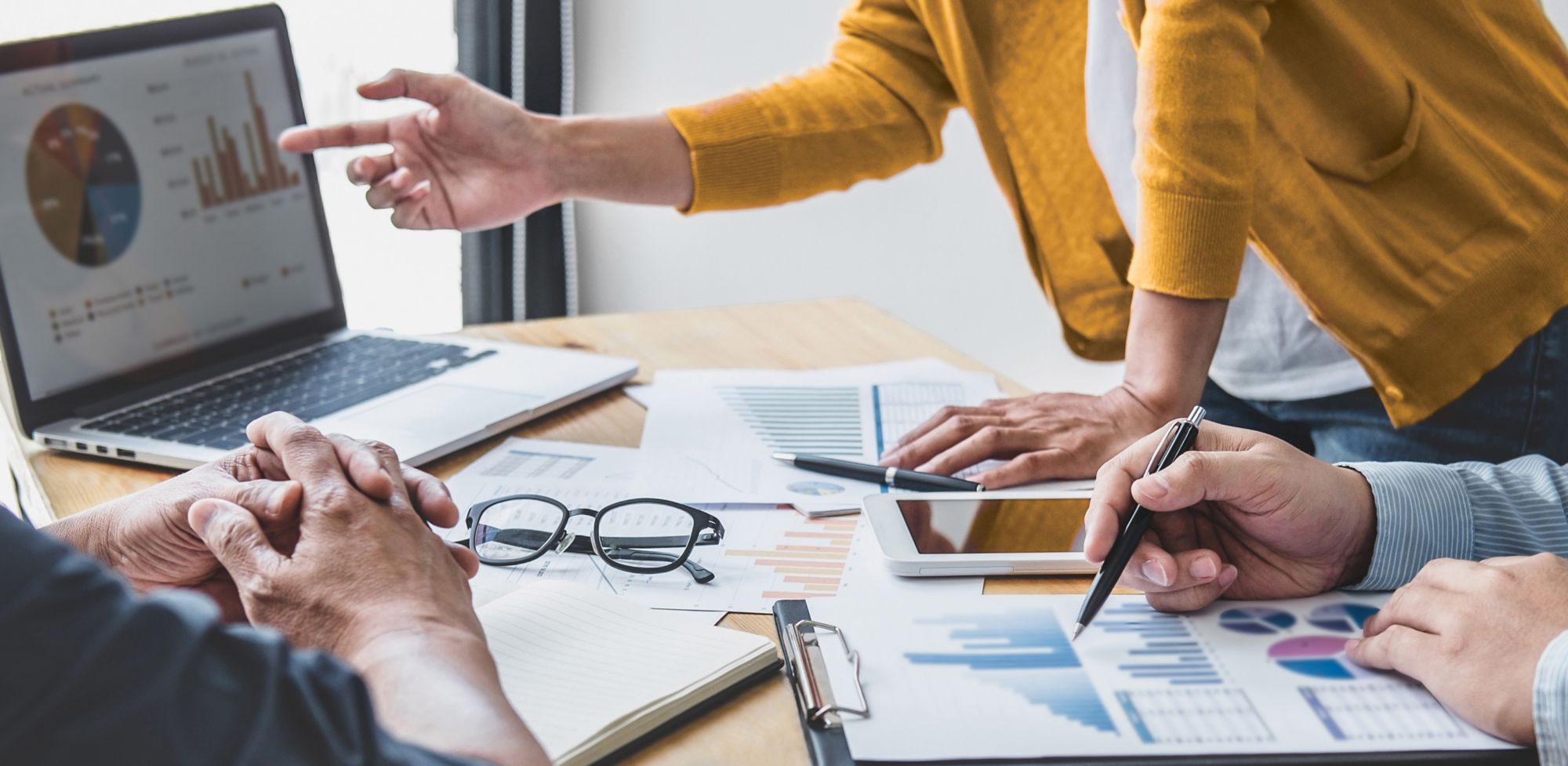 Employees going over analytics during meeting. 