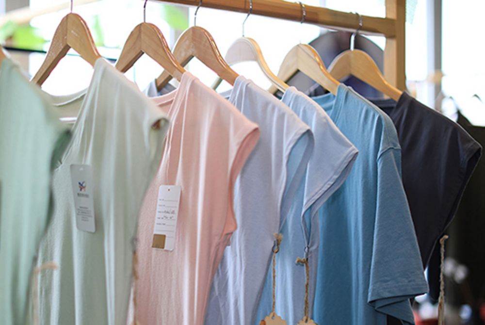 Naia clothes hanging on a rack. 