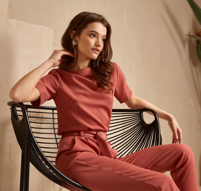 A person in a pink shirt and pants set. 