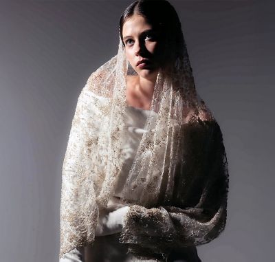 A model wears a white garment and veil made with Naia Renew.  