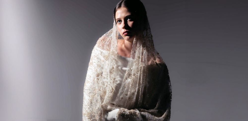 A model wears a white garment and veil made with Naia Renew fibers 