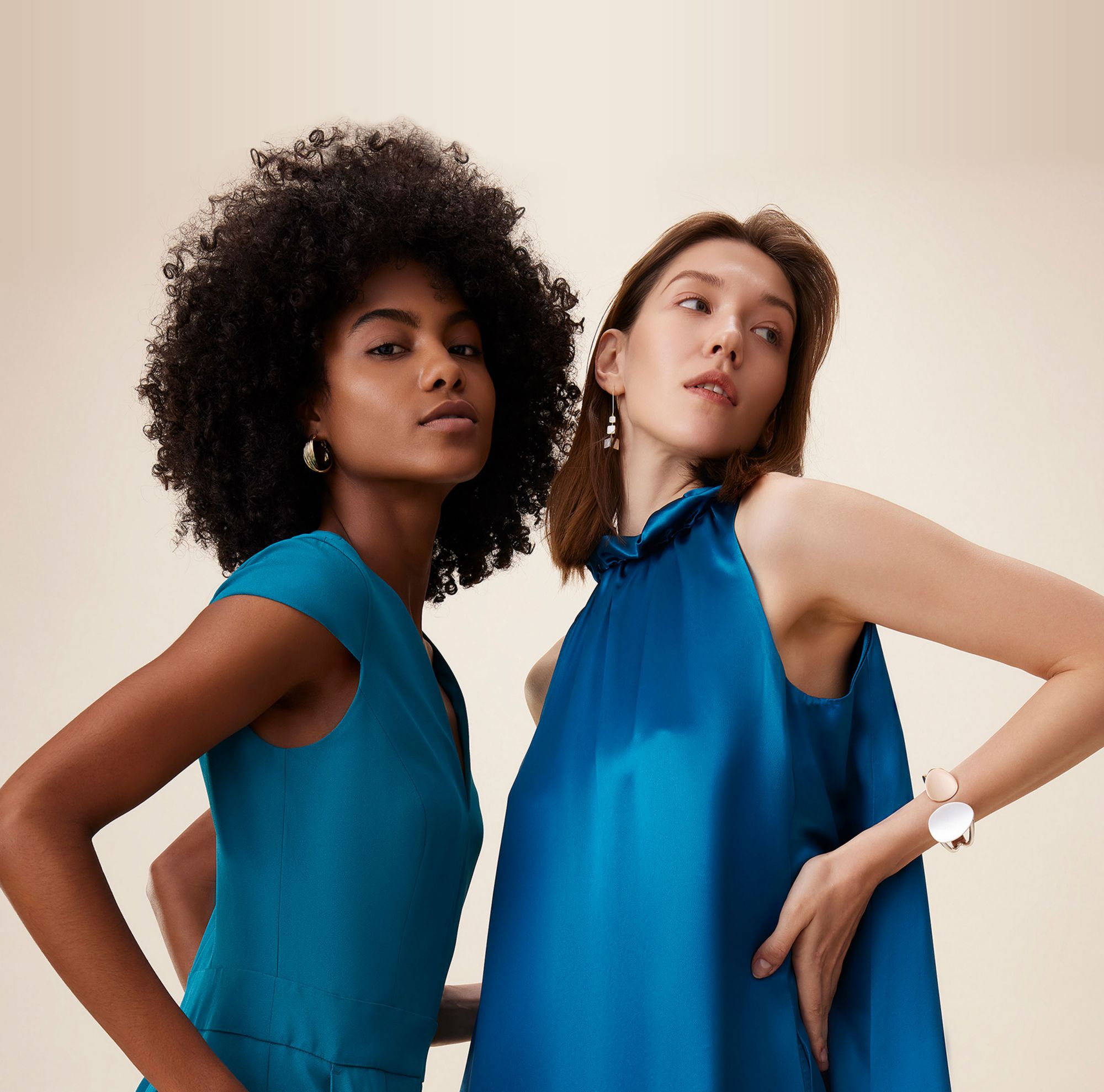 Models posing in blue Naia clothing. 