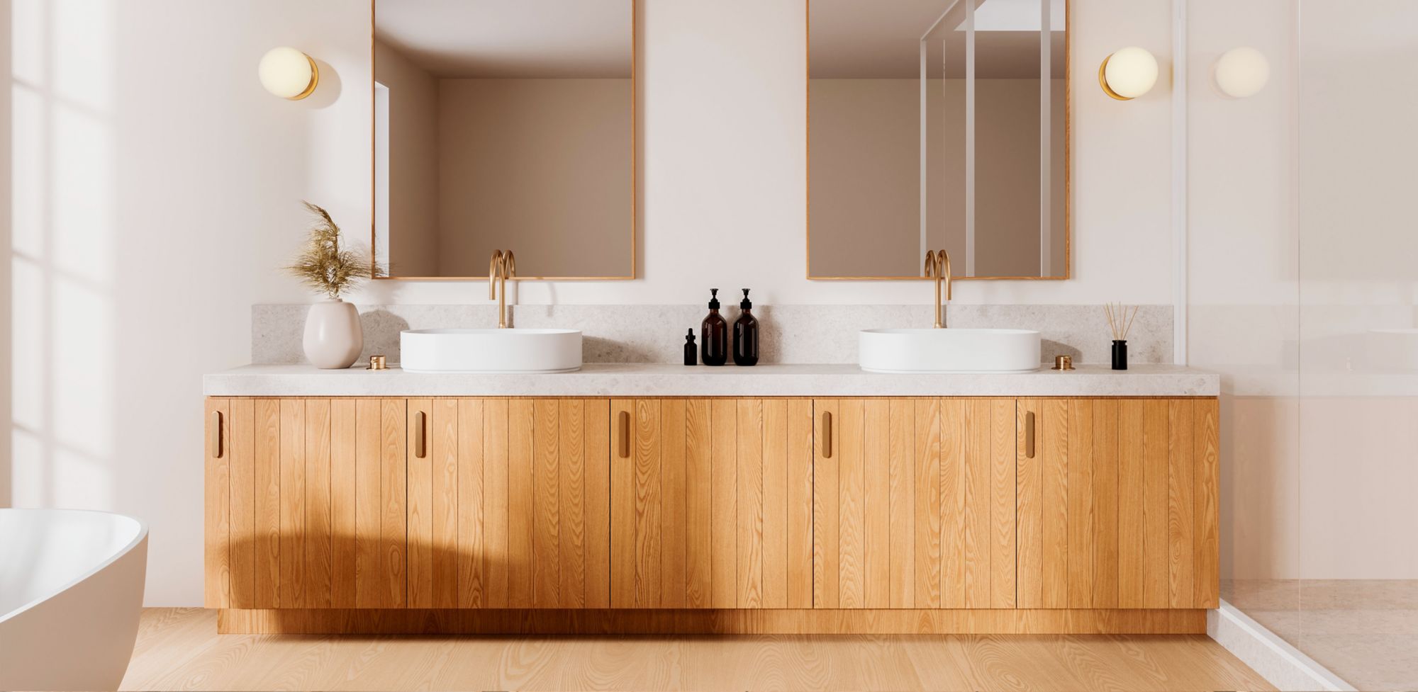 A modern white bathroom with double sinks and wood cabinets. 