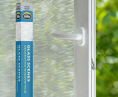 Retail packaging displayed next to a window treated with the Ocean Waves decorative film.
