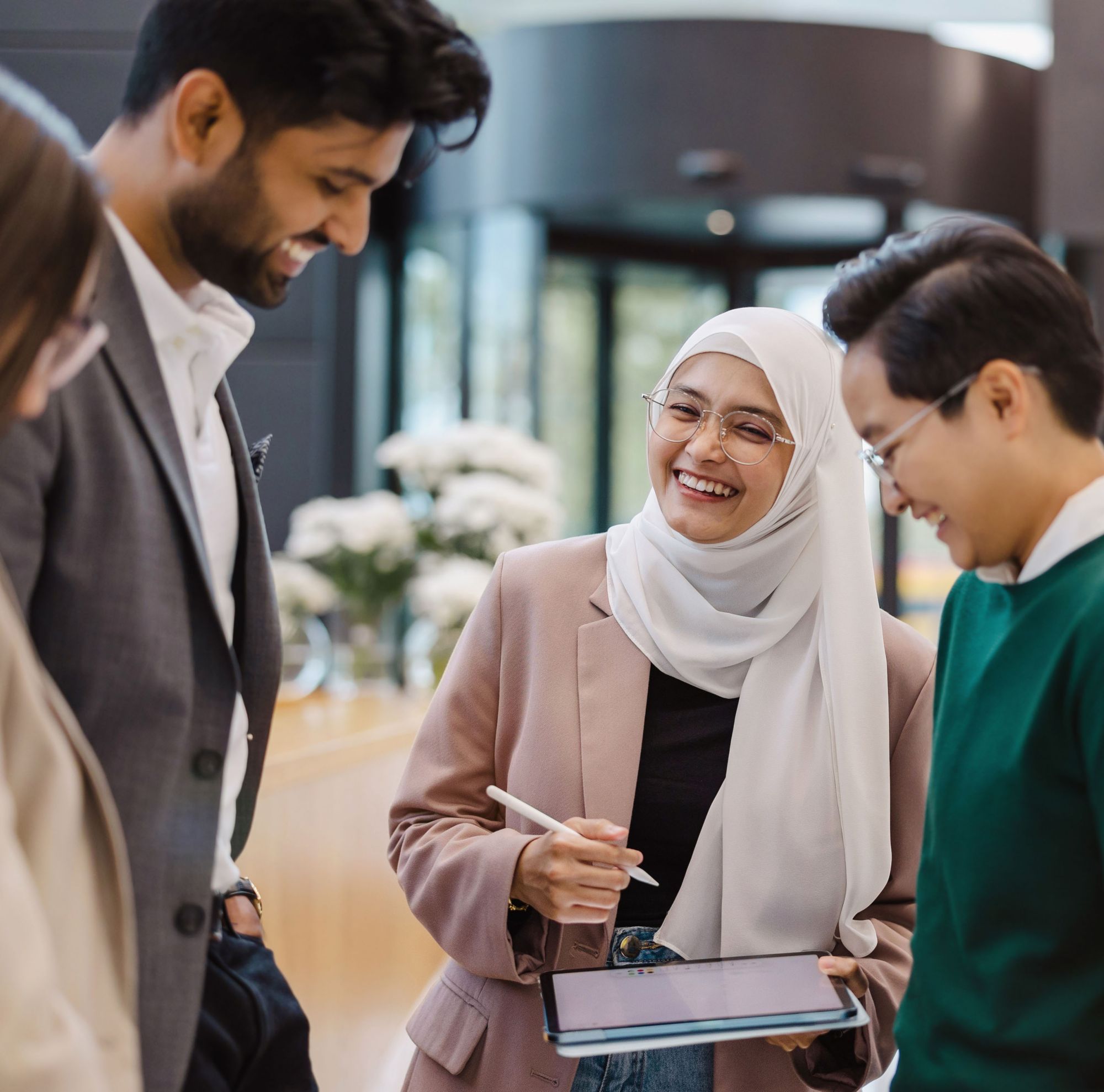 Office colleagues laughing together. 