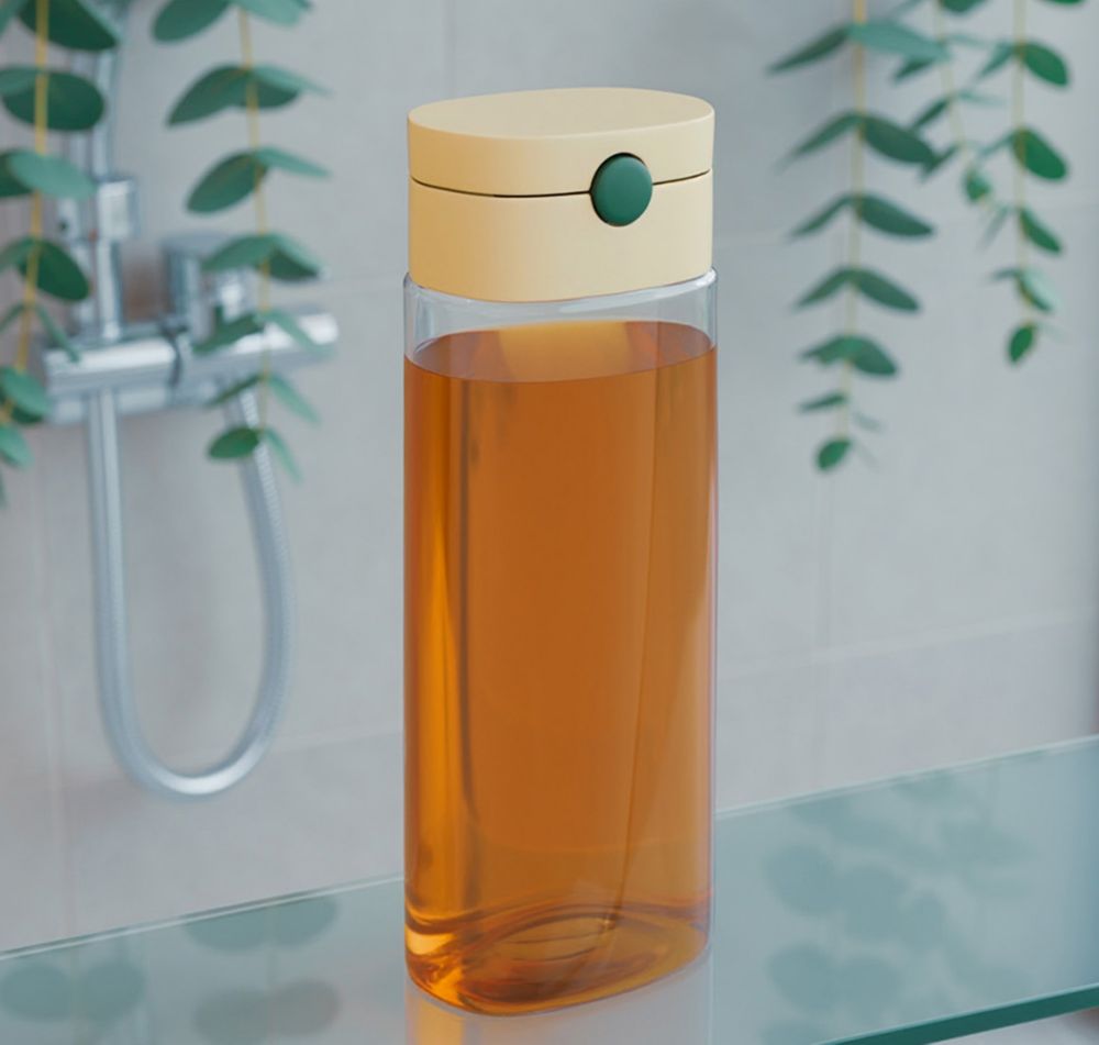 Clear shampoo bottle made from recycled PET, filled with orange shampoo.  