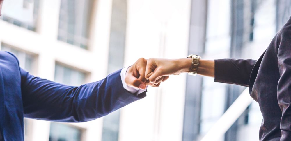 Partnership corporate team fist bump