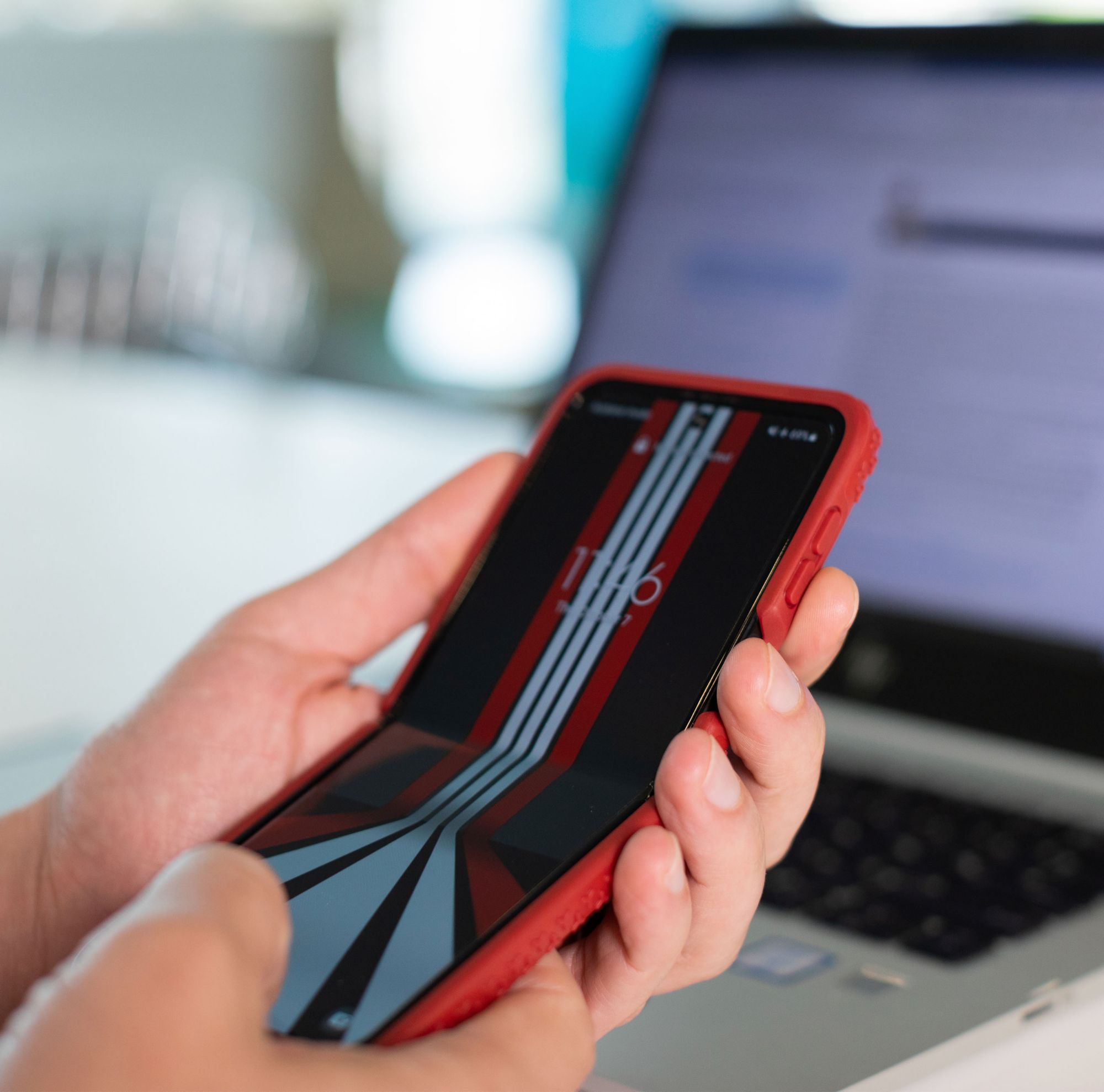 A person examines their phone. 