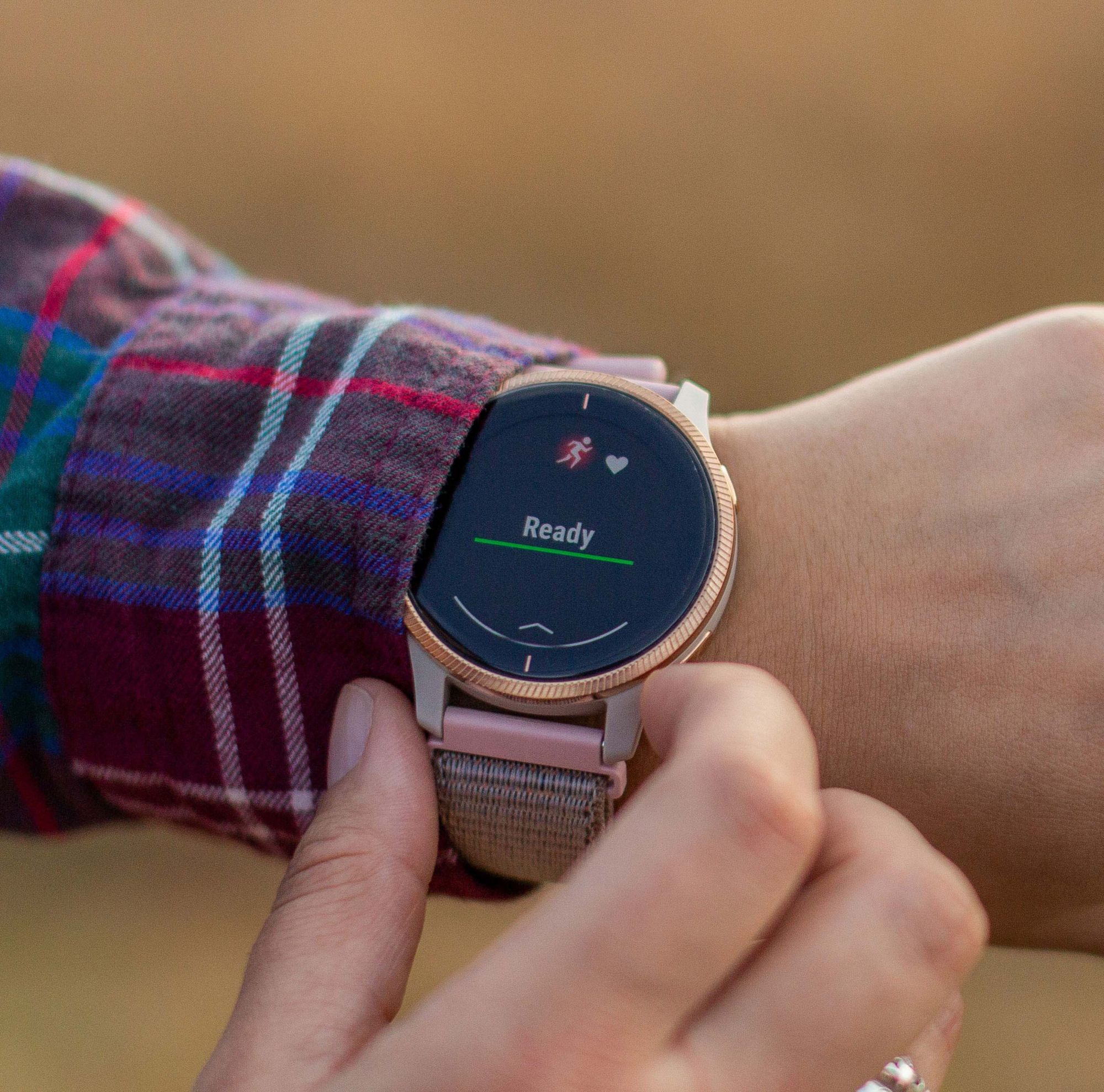 A person examines their watch. 