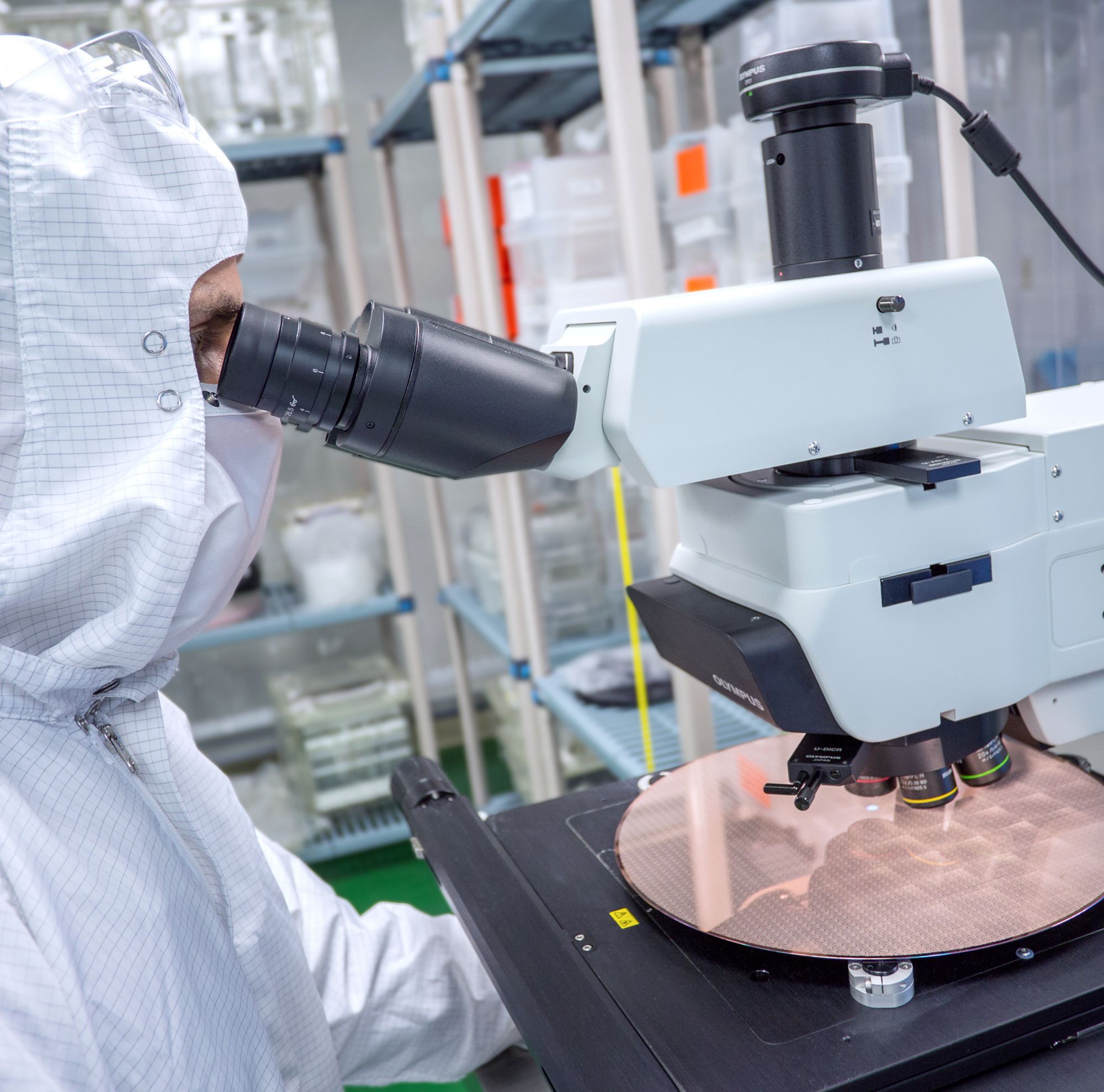 A technician uses a microscope 