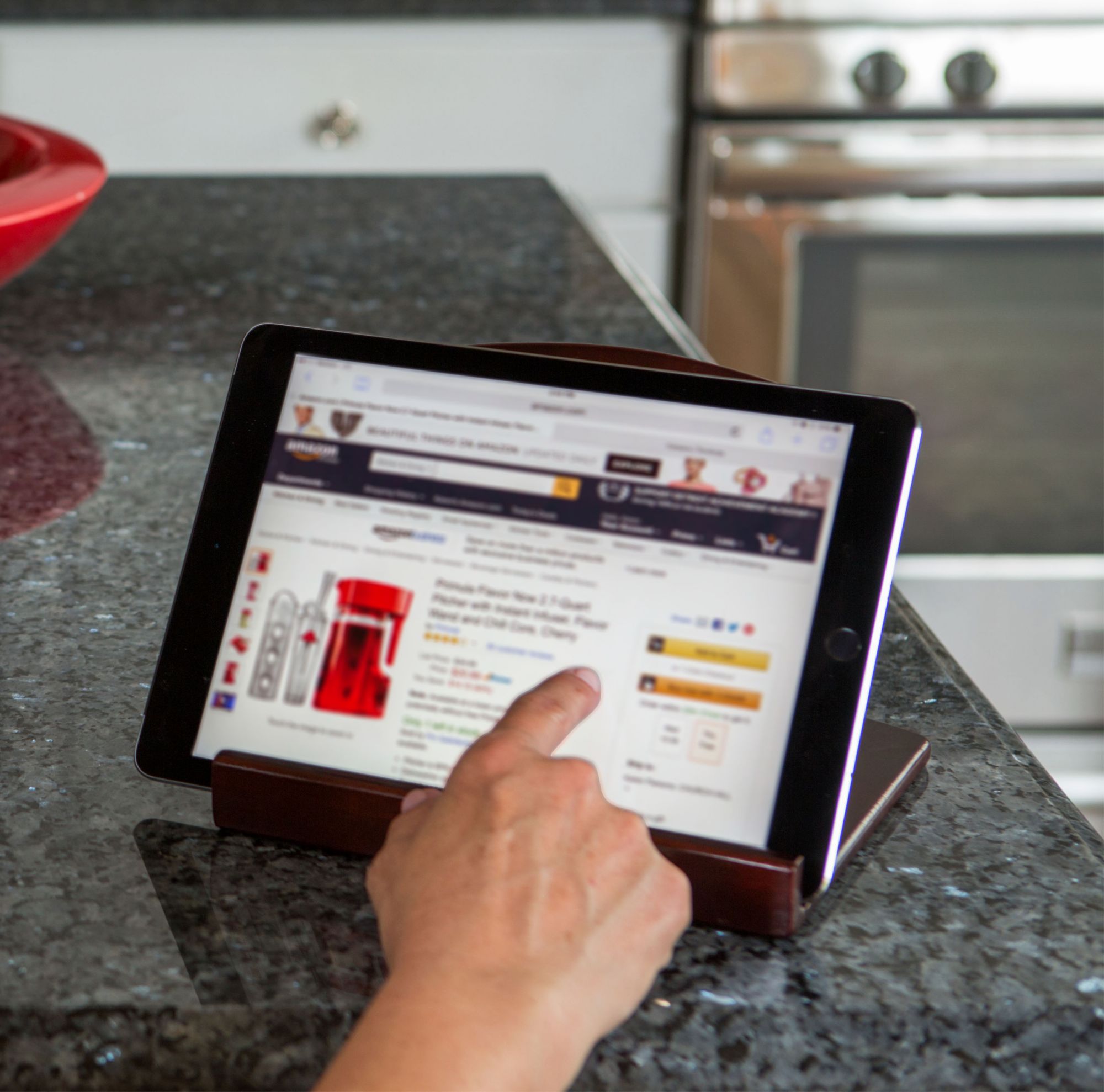 A person uses a tablet to shop online. 