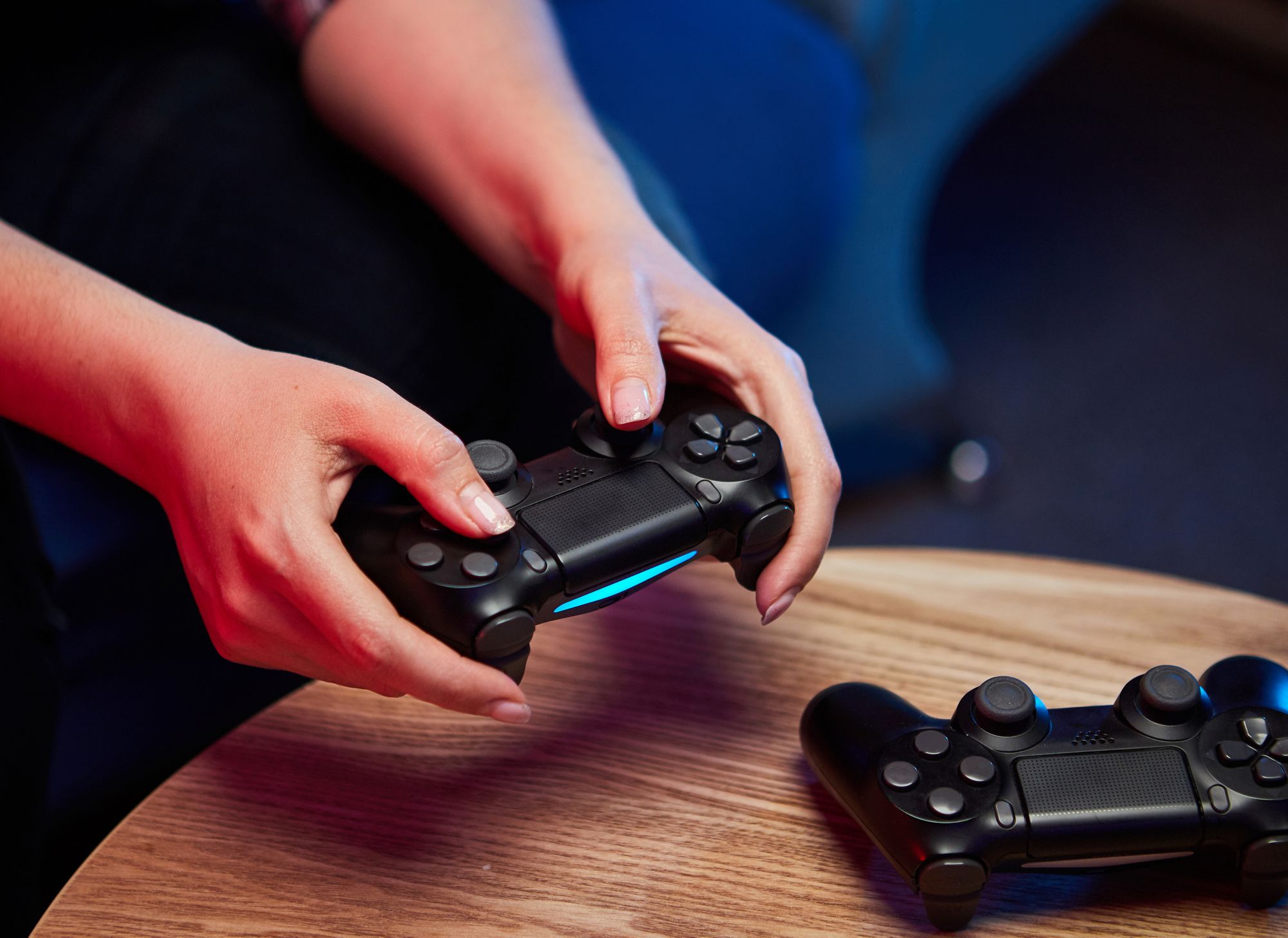 Close up of hands holding a video game controller. 