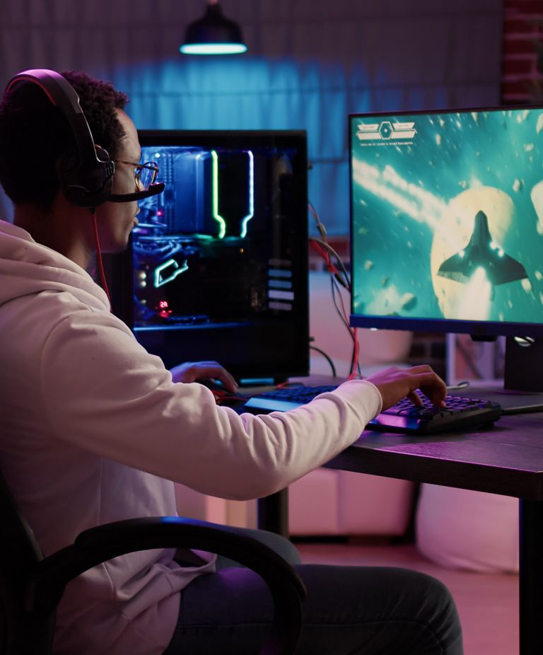 A gamer wearing a headset while playing video games. 