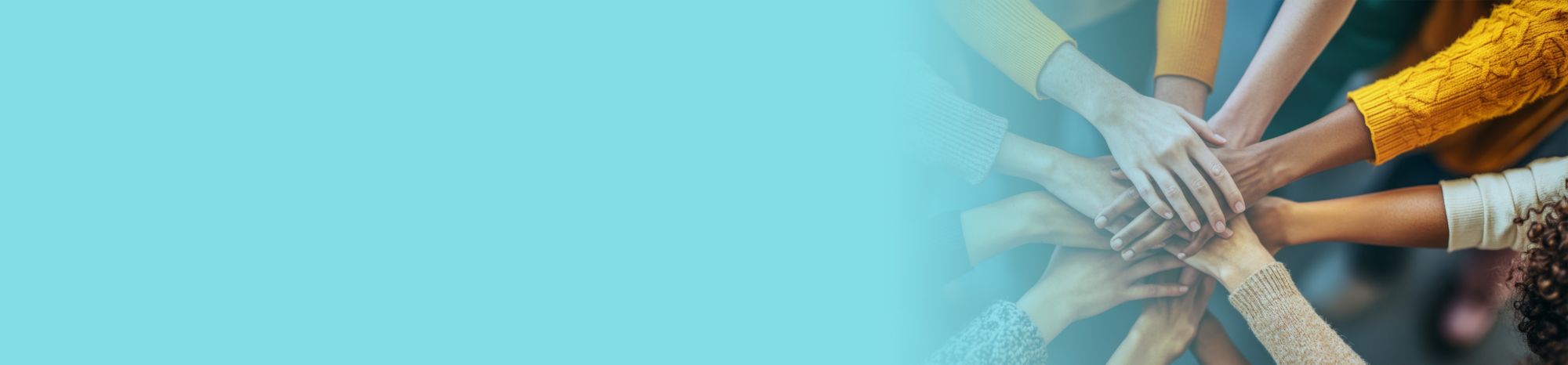 The hands of 10 people are together in a circle, showing teamwork.  