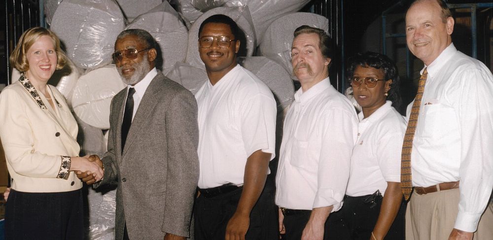 Pevas Bailey and his uncle in a photograph from 1988 in front of fabric rolls 