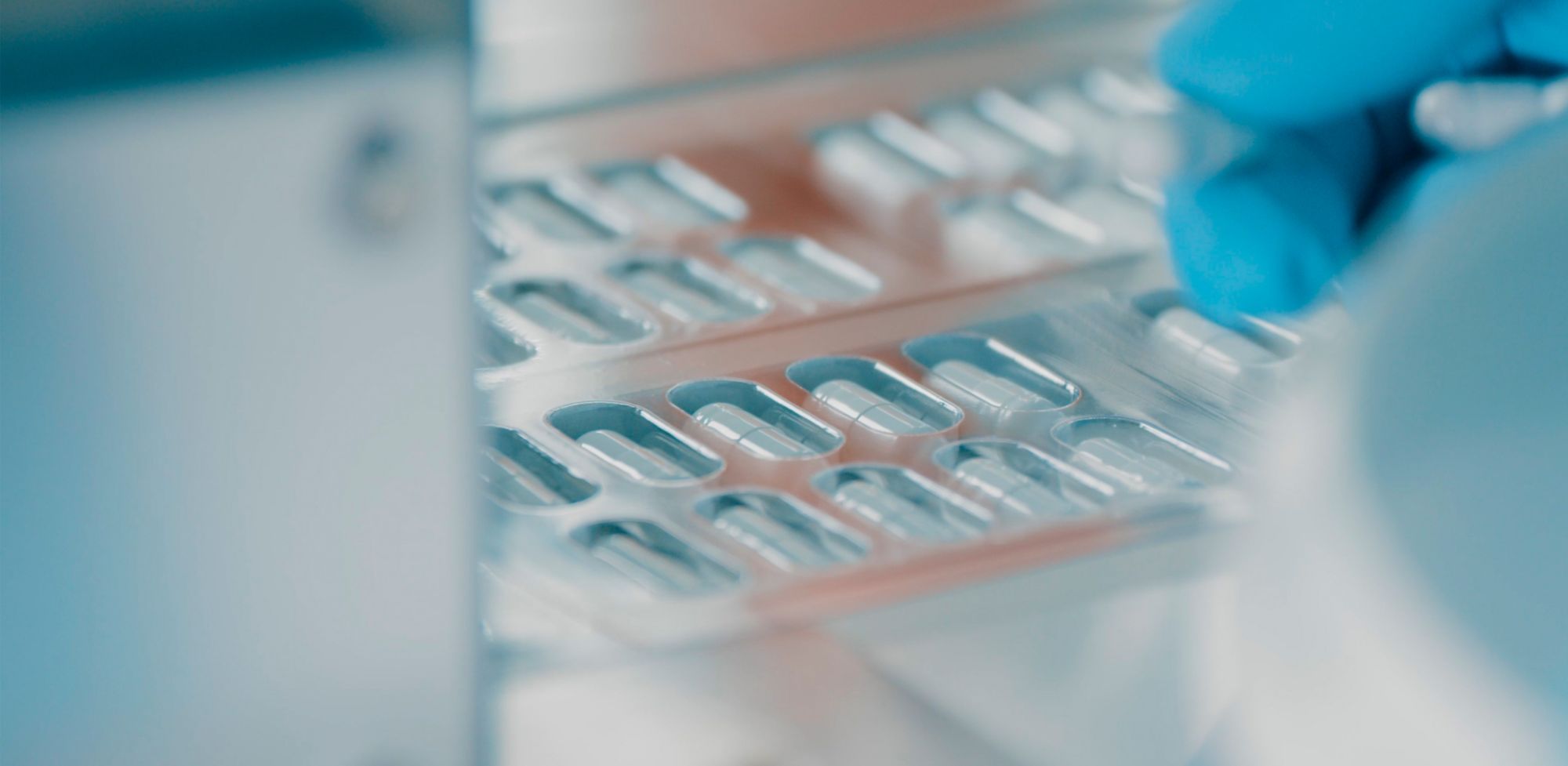 A pharmacologist examines medicinal capsules. 