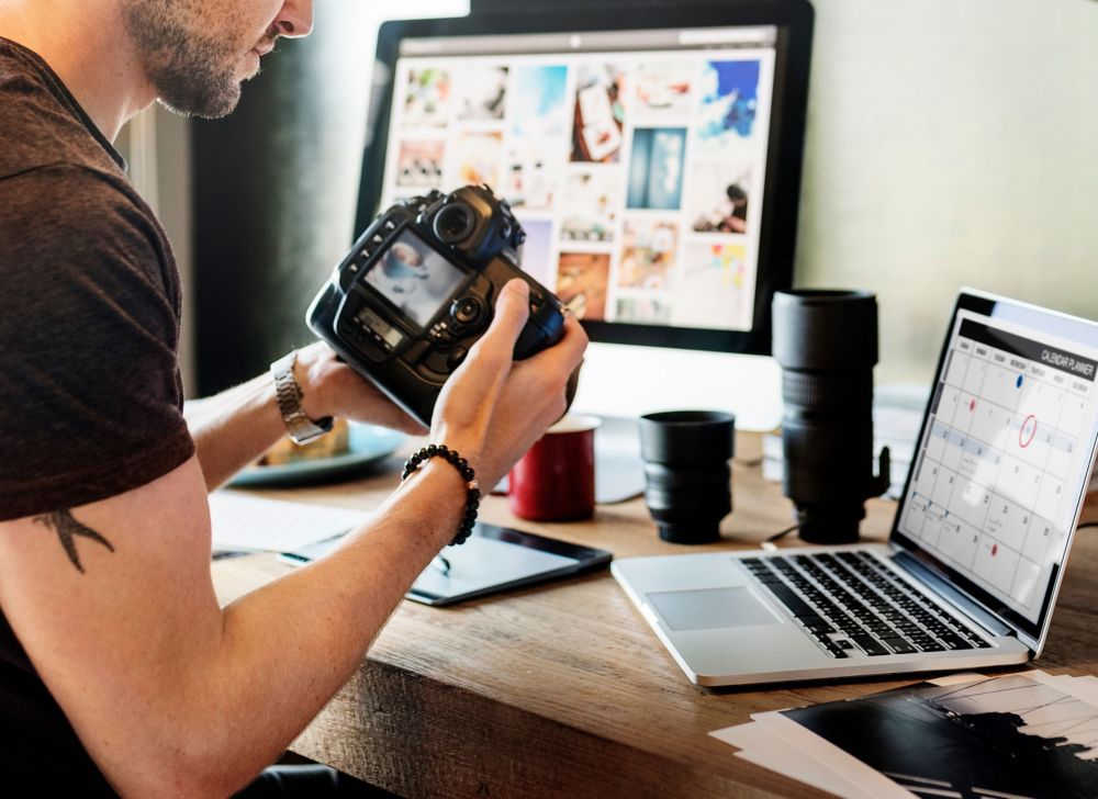 A photographer examines an image on his digital camera display. 