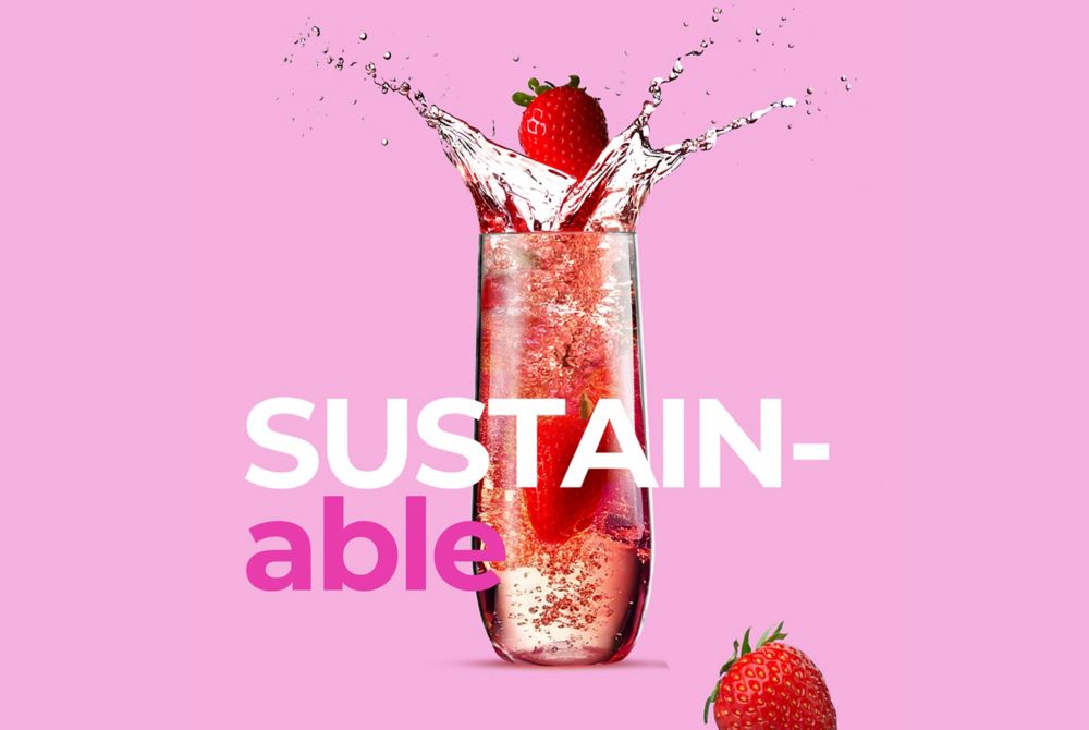 Rowdy crowd champagne flutes filled with pink strawberry champagne; the overlaid text reads “SUSTAINABLE.”    